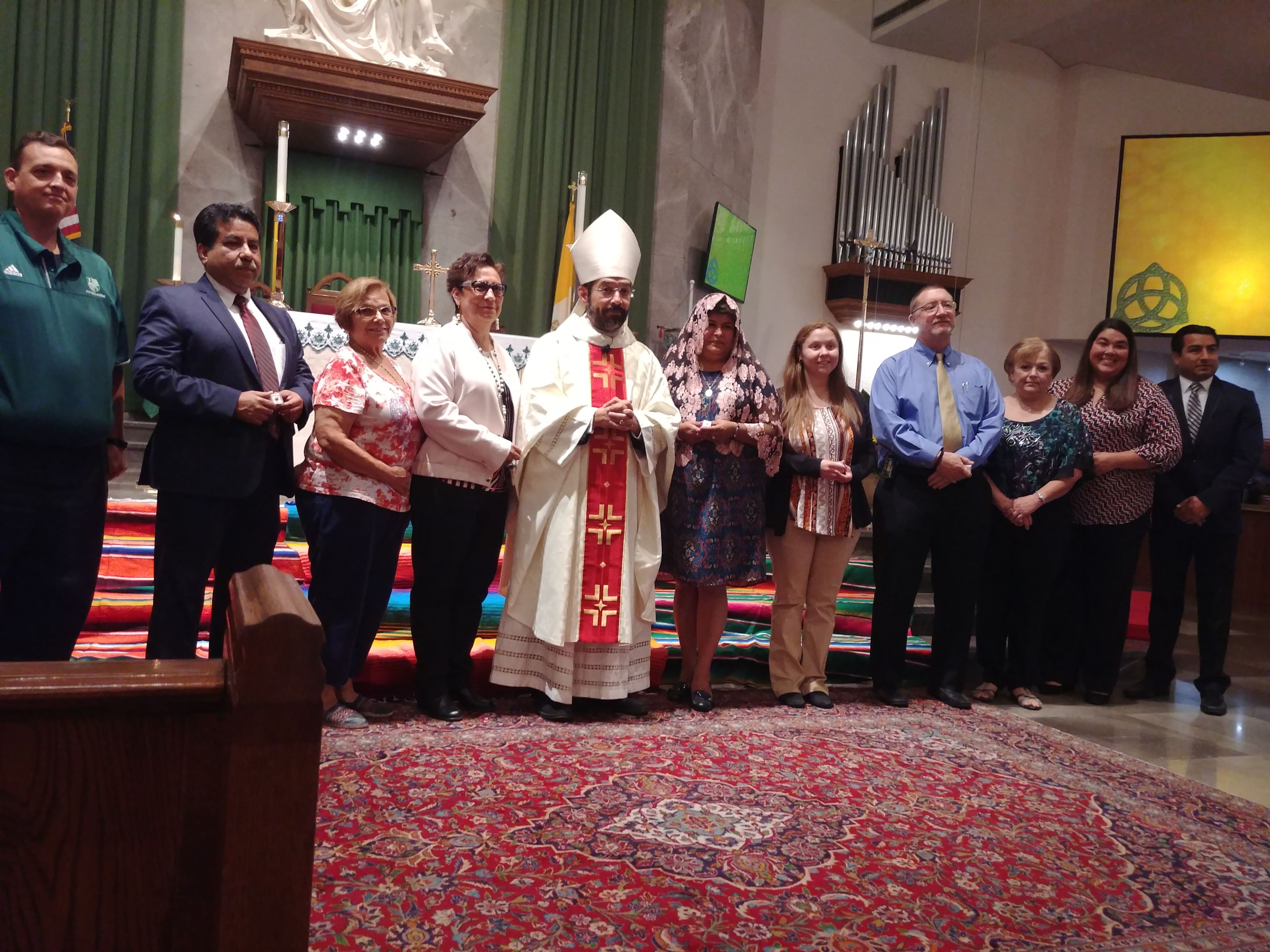 Ms. Yesenia and Ms. Diana with Bishop Flores