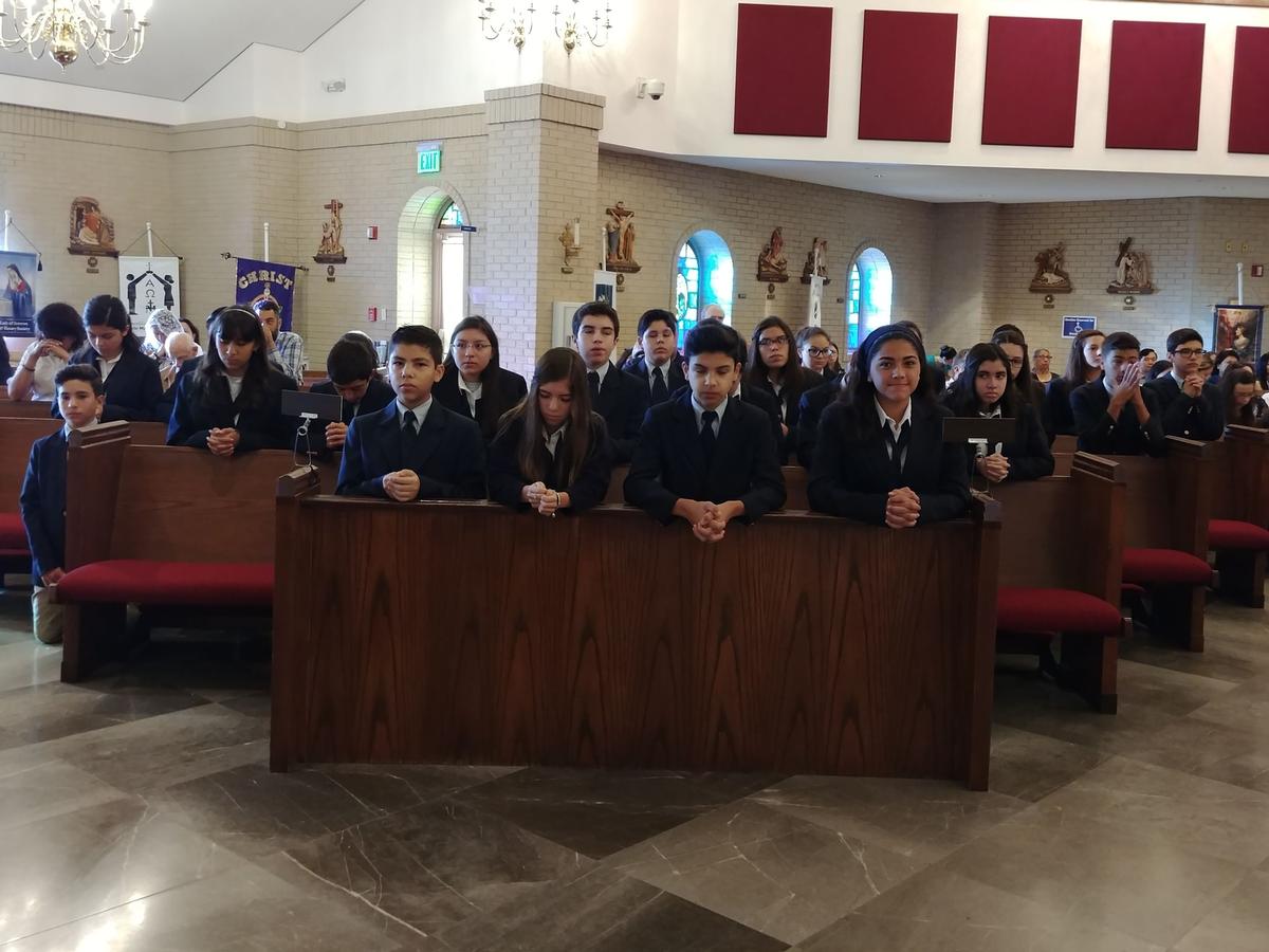 8th Grade Students Praying during Holy Mass
